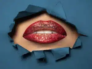 red lips breaking through wrapping paper