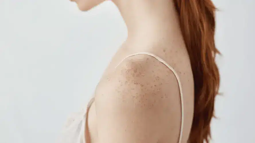 a woman's torso with her red hair over her back