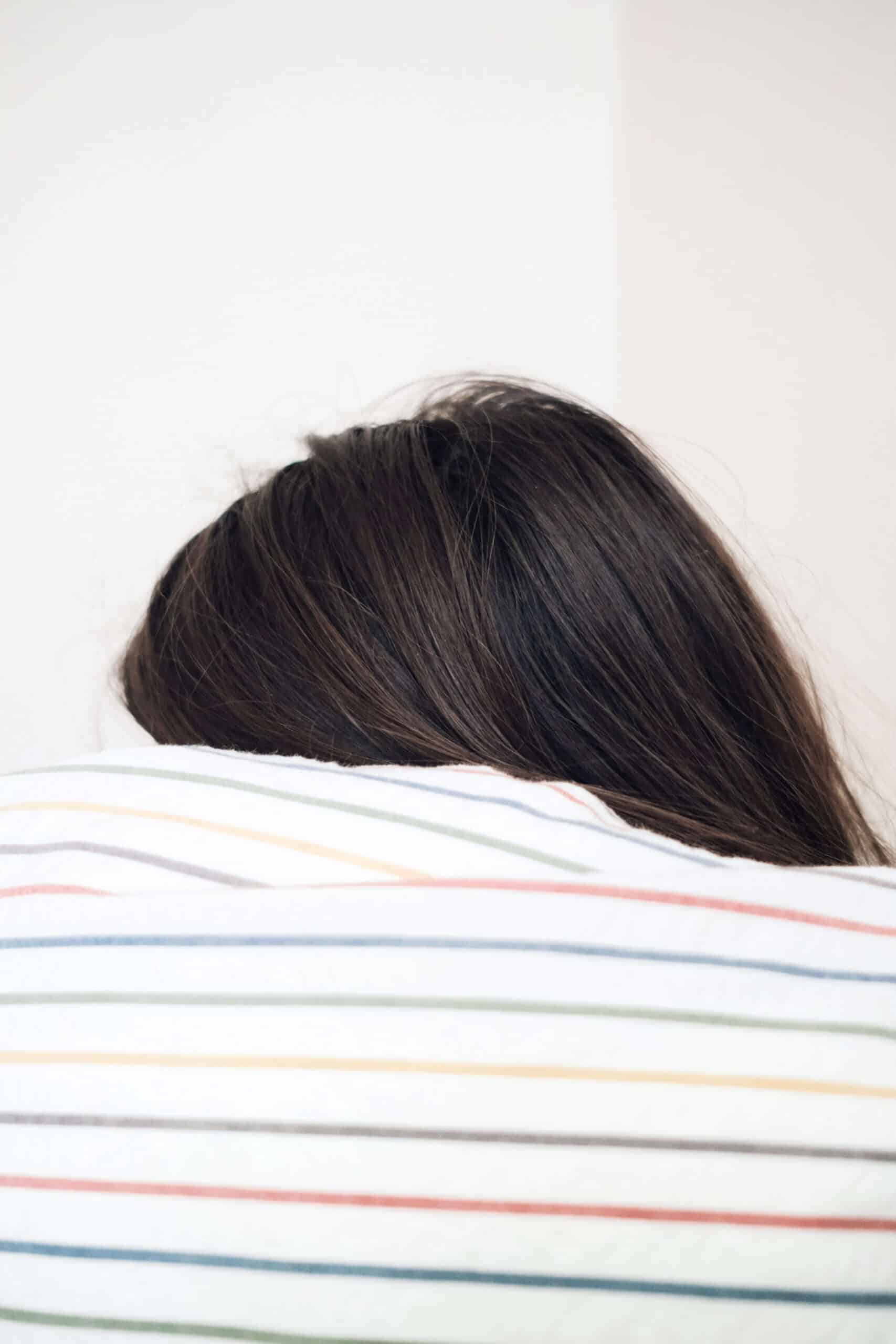 lady resting her head on pillow