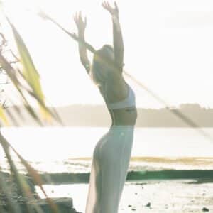 lady with arms in the air overlooking lake