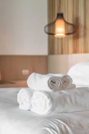 White towel on bed in hotel and resort