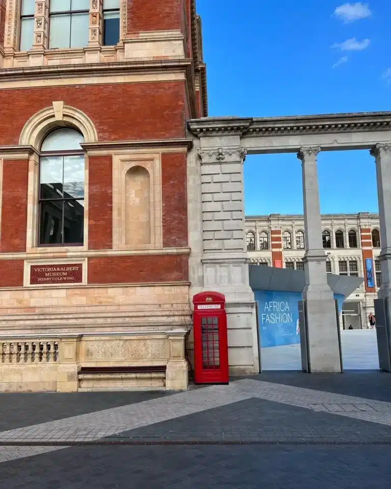 view of victoria and albert museum from exhibition road entrance with the iconic red phone booth