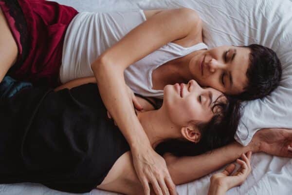 man and woman sleeping together in an embrace