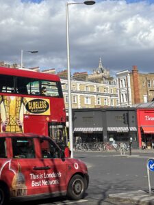 a view of south kensington tube station sw7 with bus and taxi in teh foreground