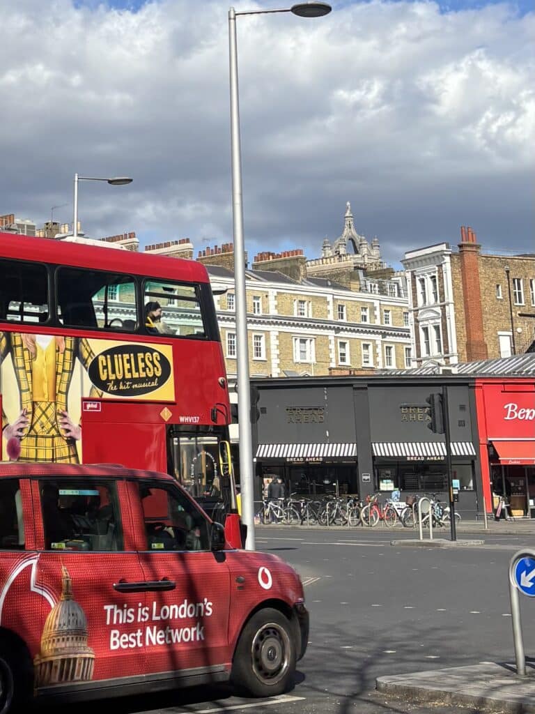 a view of south kensington tube station sw7 with bus and taxi in teh foreground